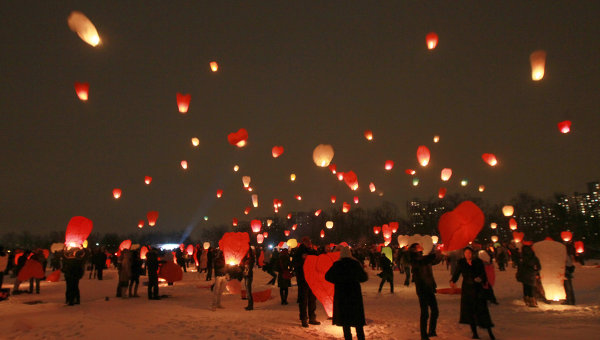 В День всех влюбленных молодые люди запускают в небо красные фонарики в форме сердец; фото:РИА