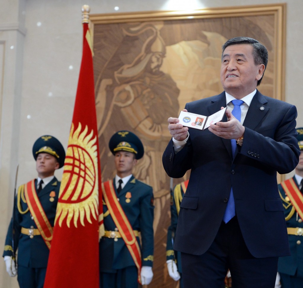 Сооронбай Жээнбеков показывает удостоверение президента КР; фото: president.kg